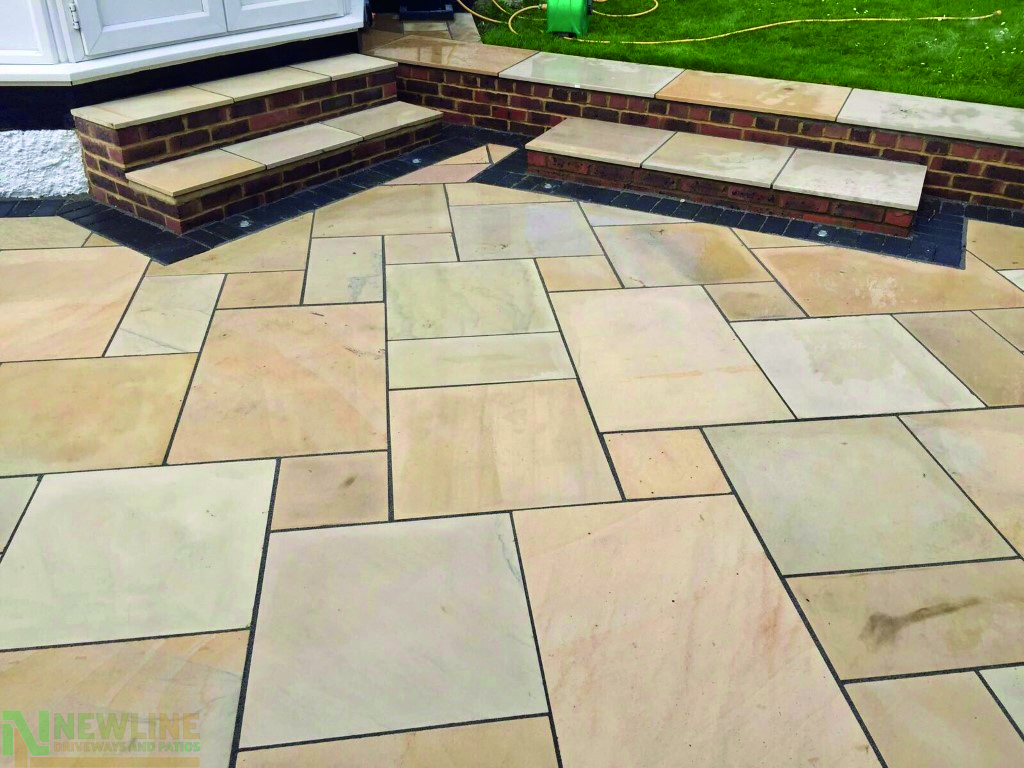 Newly laid patio in a landscaped garden